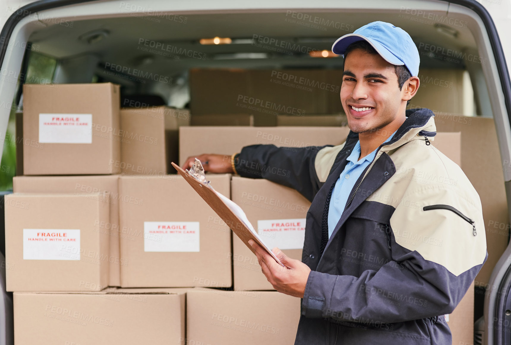 Buy stock photo Portrait of a delivery man standing next to a van full of boxes