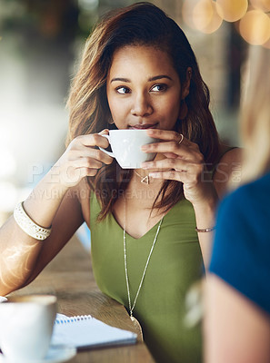 Buy stock photo Cropped shot of a woman chatting to her friend in a cafe