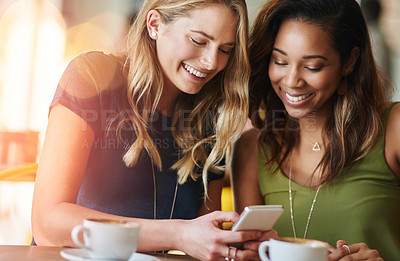 Buy stock photo Women, friends and coffee shop with cellphone or funny meme with laughing, social media or restaurant. Female people, smile and smartphone in New York cafe with internet humor, bonding or caffeine