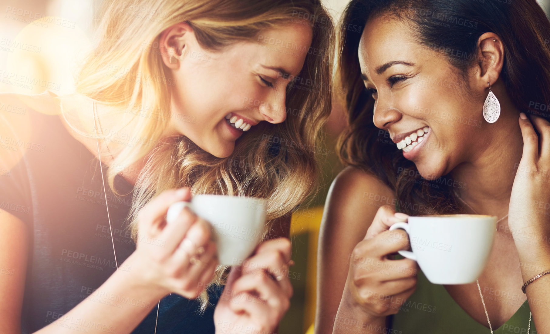 Buy stock photo Cropped shot of girlfriends enjoying their coffee at a cafe