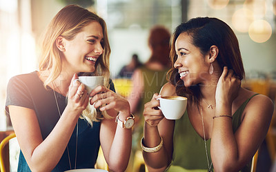 Buy stock photo Cropped shot of girlfriends enjoying their coffee at a cafe
