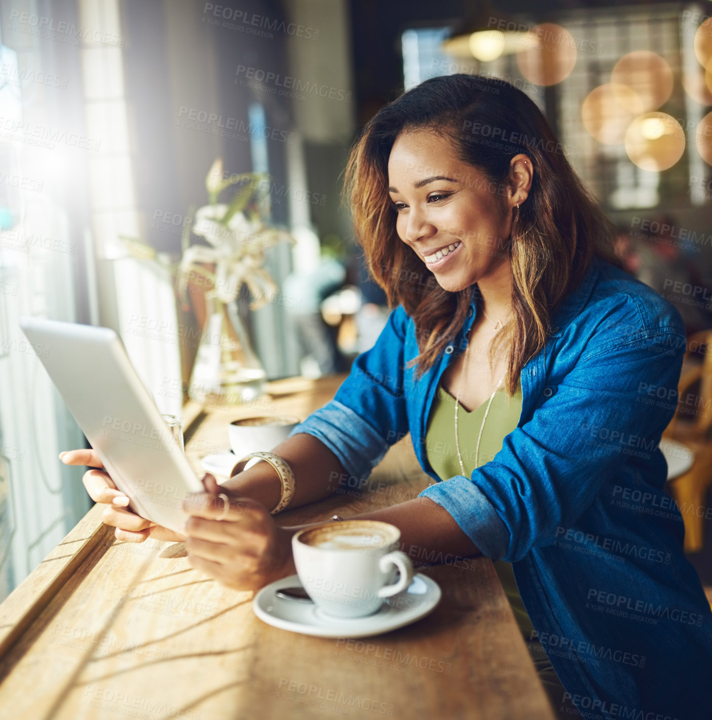 Buy stock photo Cropped shot of an attractive young woman using a digital tablet in a cafe