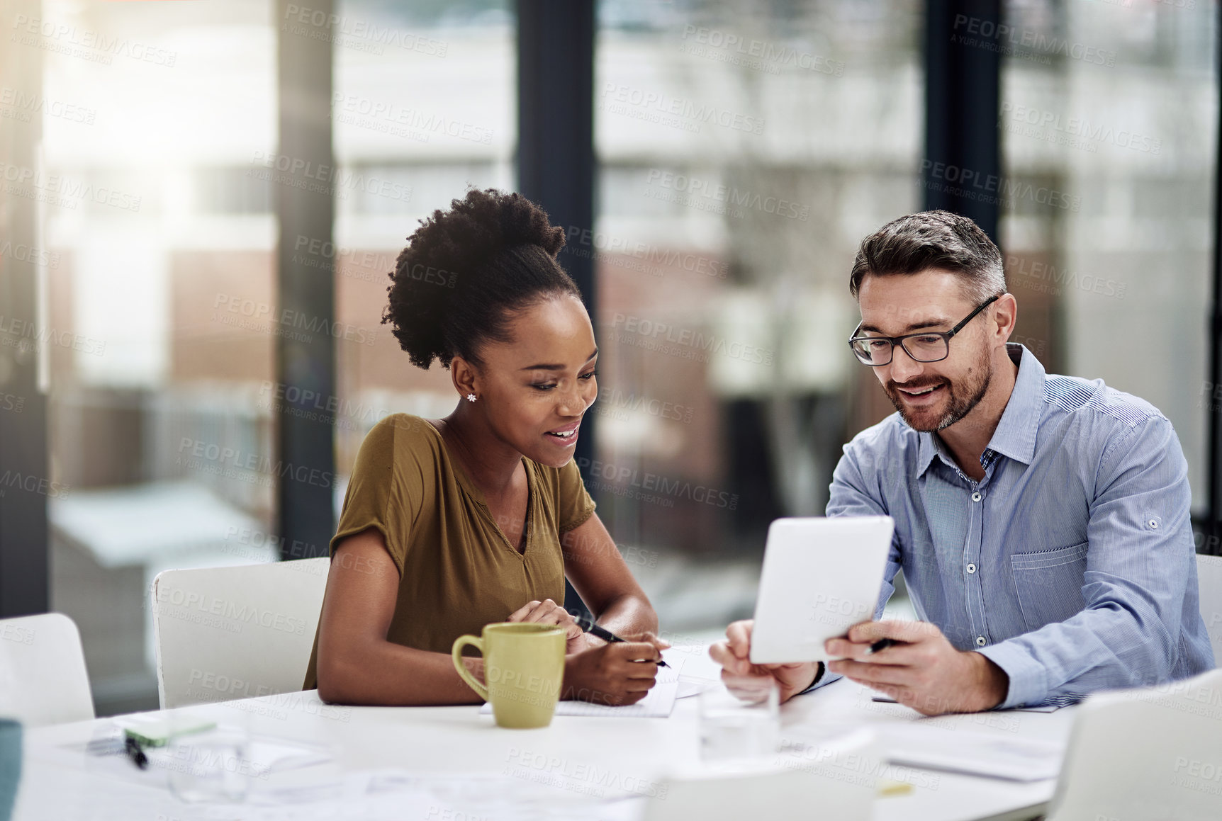 Buy stock photo Cropped shot of businesspeople discussing something on a digital tablet