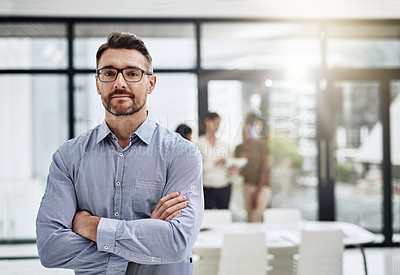 Buy stock photo Defocused shot of a businessman posing with his colleagues in the background