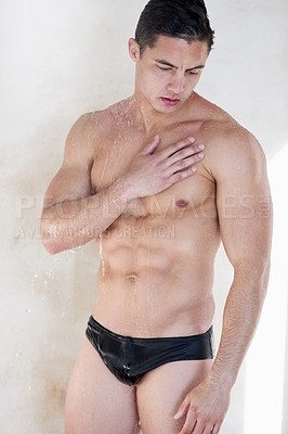 Buy stock photo Shot of a handsome young man having a refreshing shower