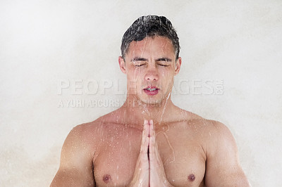Buy stock photo Shot of a handsome young man meditating while having a shower