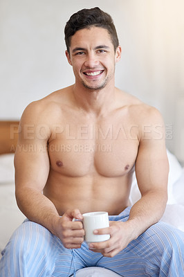 Buy stock photo Shot of a handsome young man having coffee in the morning at home
