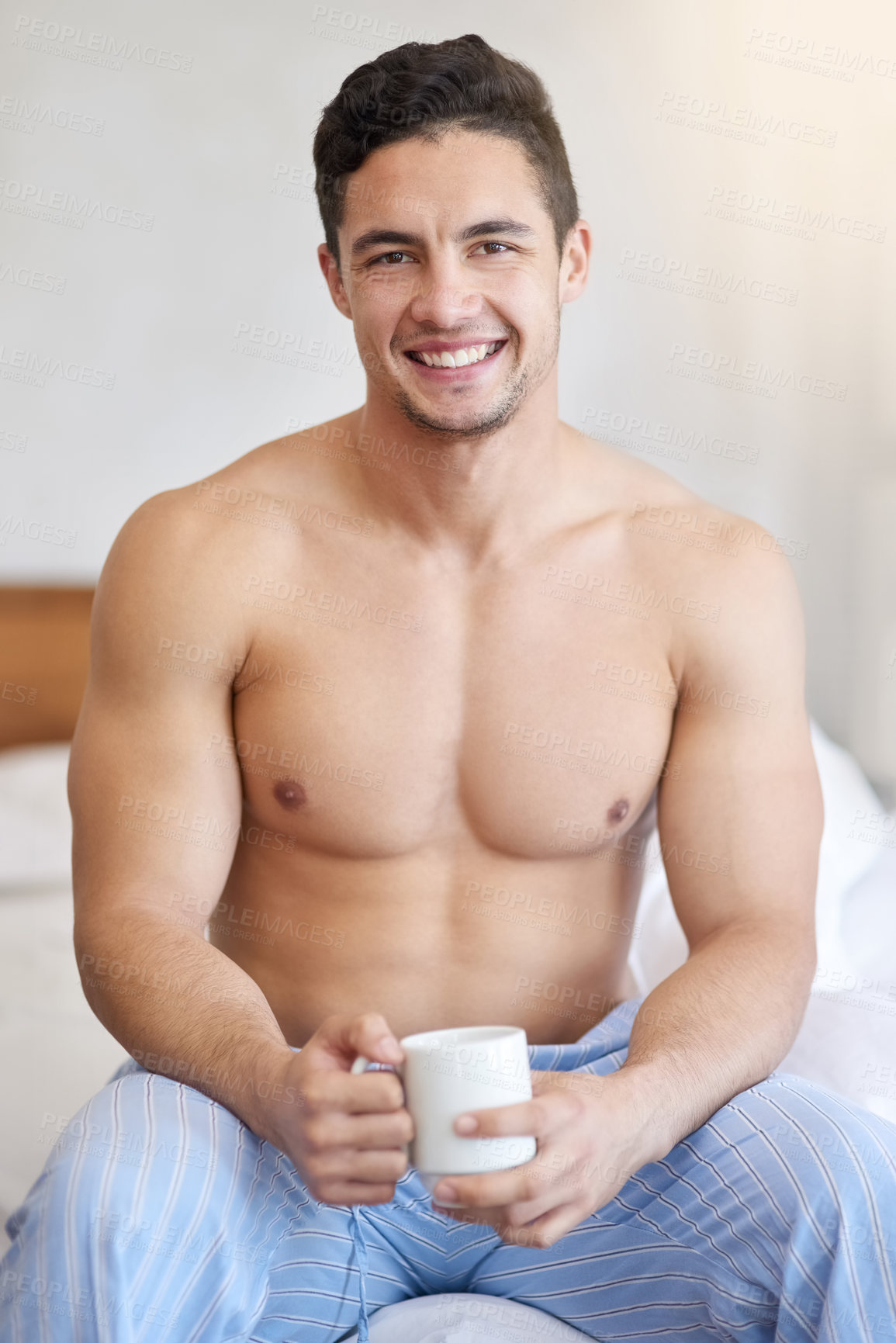 Buy stock photo Bedroom, portrait and man with coffee in morning for energy boost, caffeine and relax in vacation holiday. Home, bed and happy guy in apartment with tea cup, beverage and drinking liquid for comfort