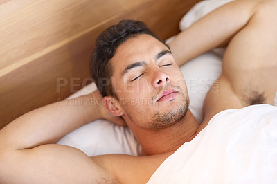 Buy stock photo Shot of a handsome young man sleeping peacefully in bed