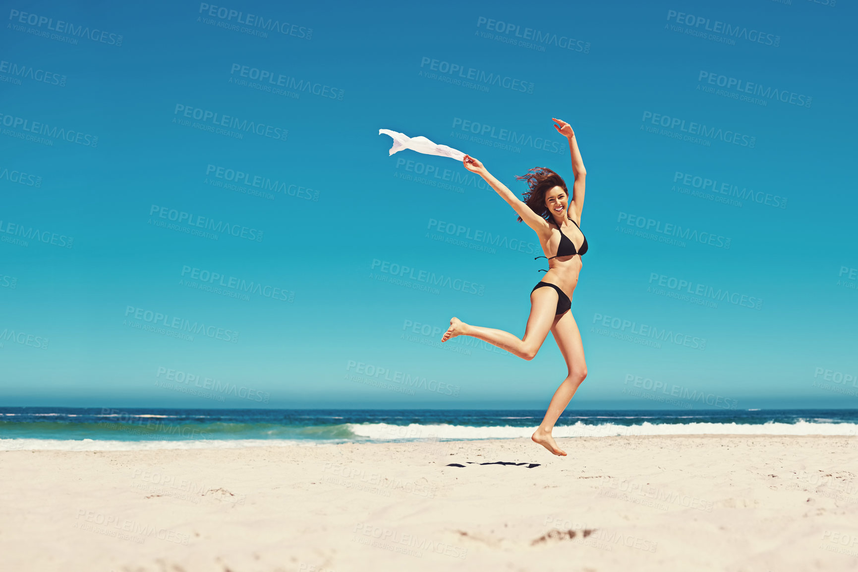 Buy stock photo Woman, portrait and bikini or ocean jump for holiday freedom on tropical island, beach or adventure. Female person, swimwear and smile in Bali for paradise weekend with summer trip, coast or sand