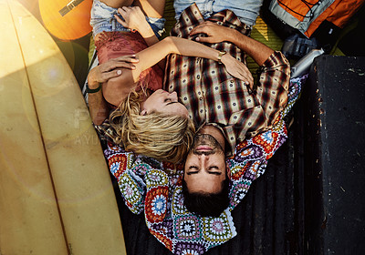 Buy stock photo Shot of a young couple lying at the back of a pickup truck to relax after a long drive