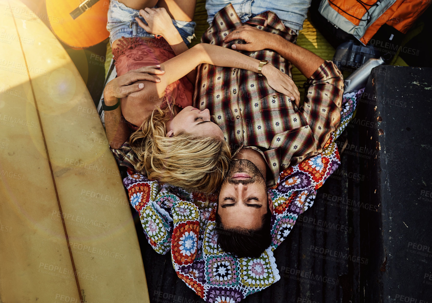 Buy stock photo Shot of a young couple lying at the back of a pickup truck to relax after a long drive