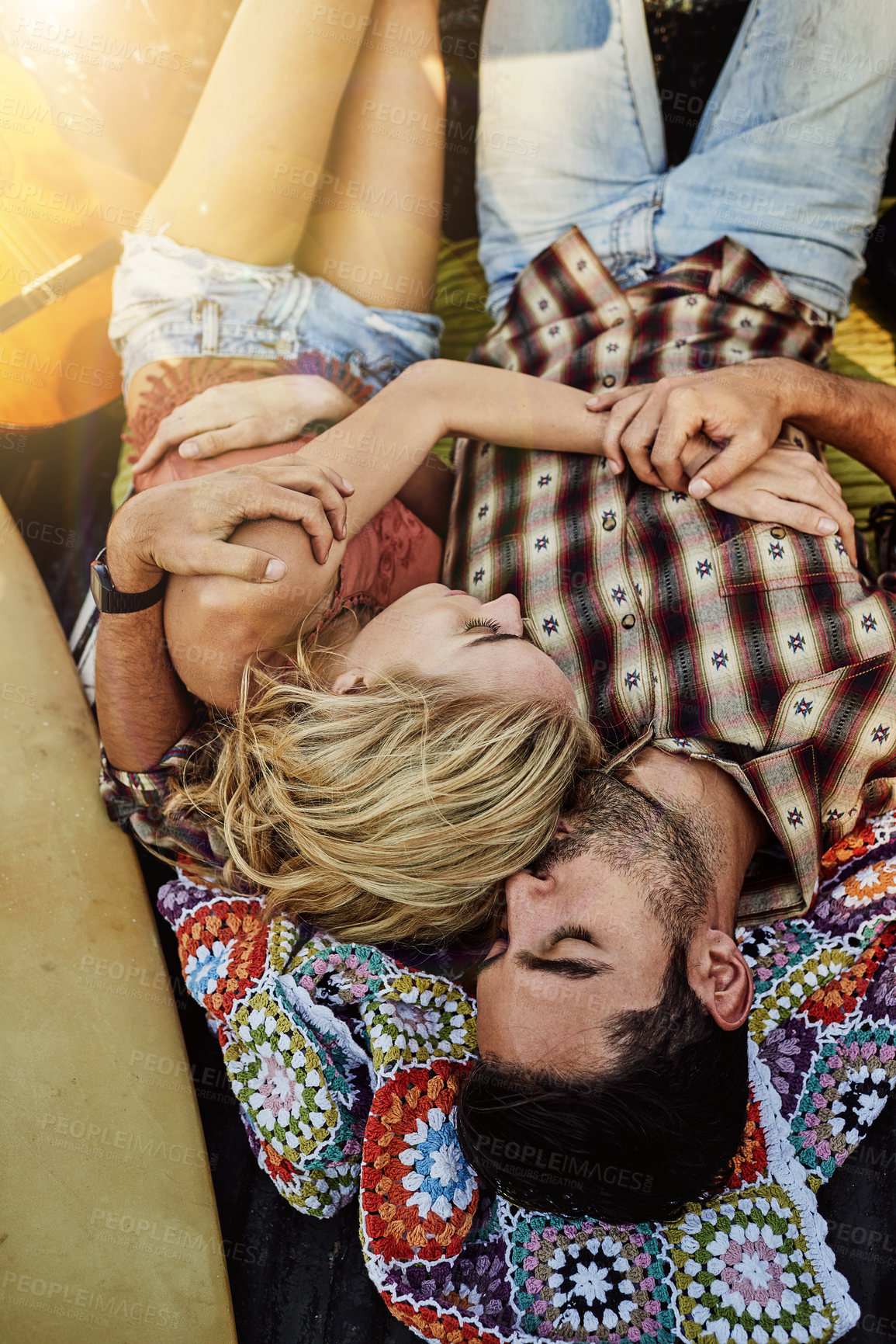 Buy stock photo Shot of a young couple lying at the back of a pickup truck to relax after a long drive