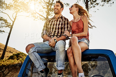 Buy stock photo Shot of an affectionate couple pulling over to admire the scenery while on a road trip