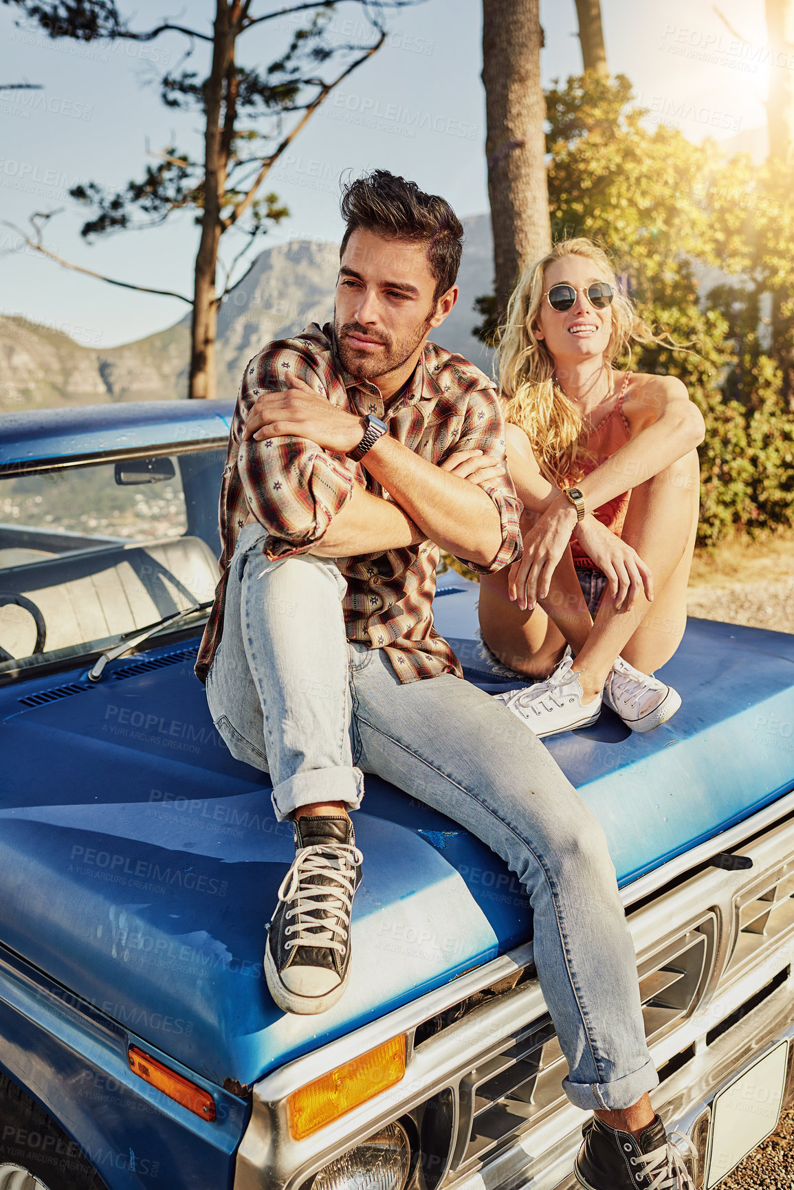 Buy stock photo Shot of a young couple sitting on their pickup stuck