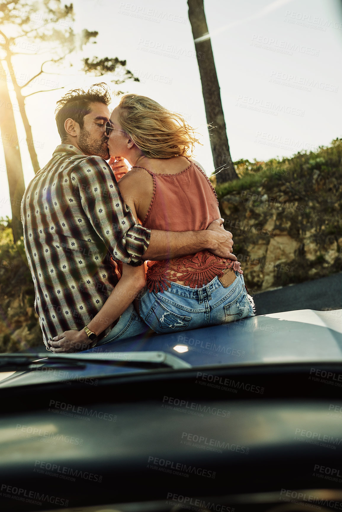 Buy stock photo Road trip, couple and kiss on car hood for love, care and connection on vacation for travel. Romance, man and woman on vehicle bonnet together for support, relax or hug partner on honeymoon holiday