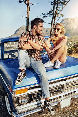 Buy stock photo Shot of a young couple out on a road trip with their truck