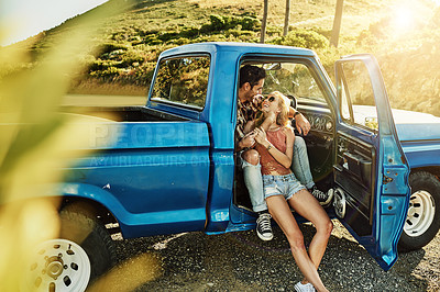 Buy stock photo Shot of a young couple out on a road trip with their truck