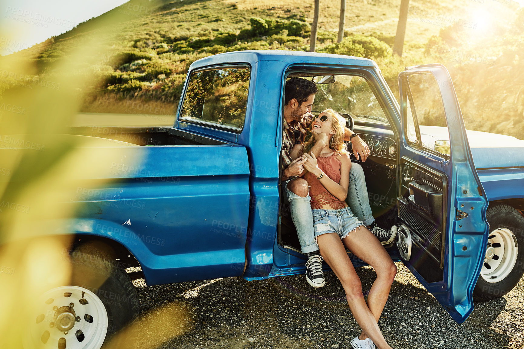 Buy stock photo Shot of a young couple out on a road trip with their truck