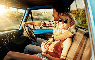 Buy stock photo Shot of a young couple out on a road trip with their truck