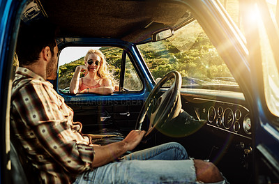 Buy stock photo Shot of a young woman standing by the window of a pickup truck