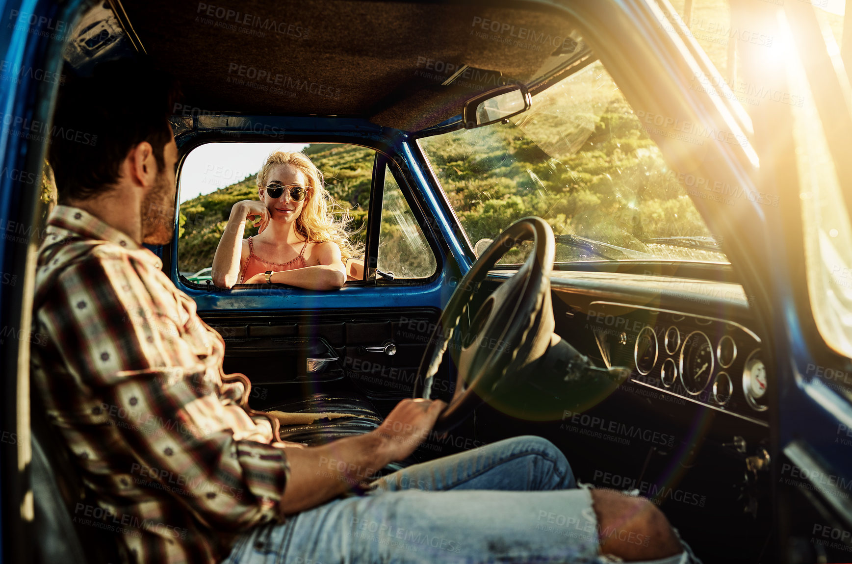 Buy stock photo Shot of a young woman standing by the window of a pickup truck