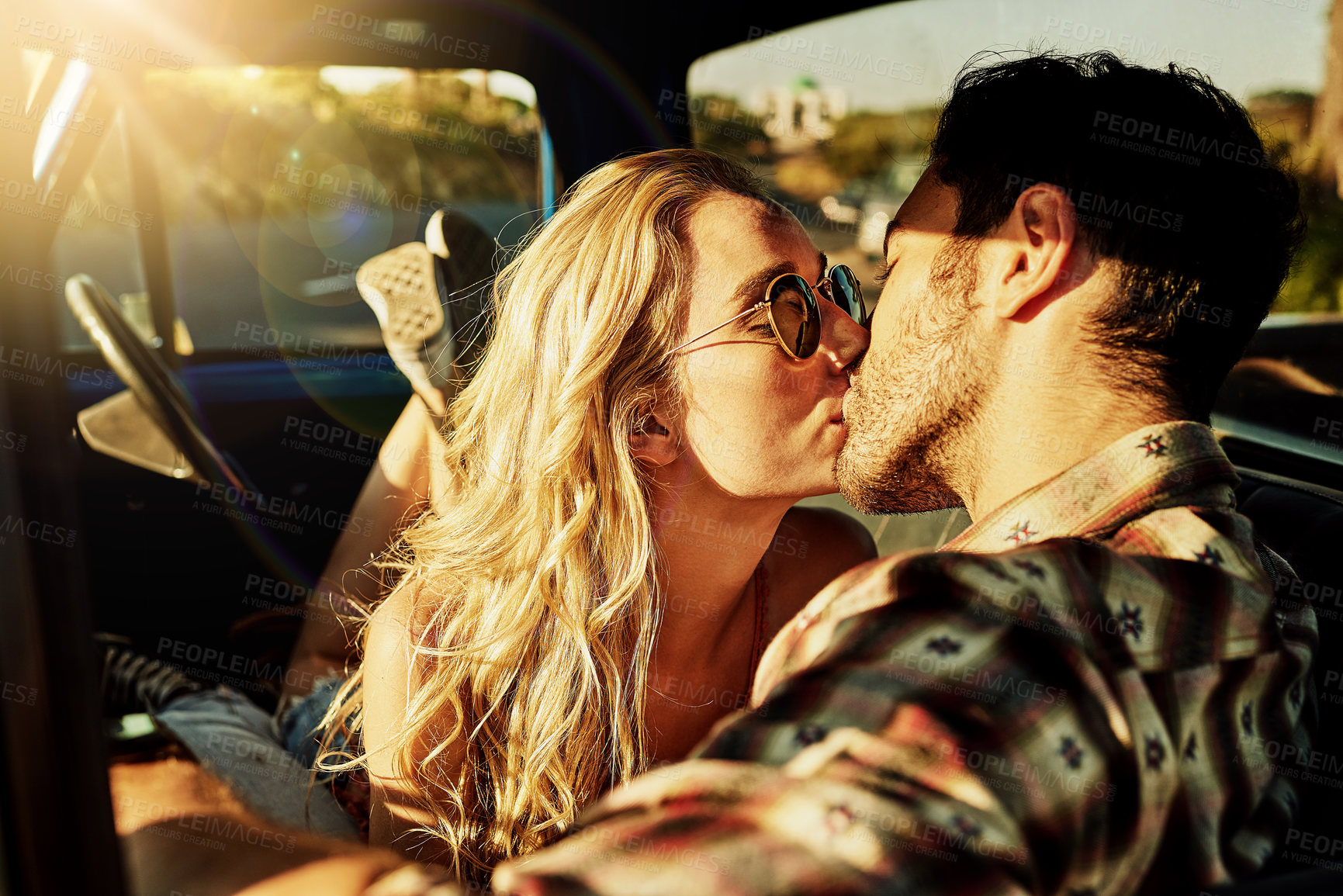 Buy stock photo Shot of an affectionate couple kissing in a pickup truck