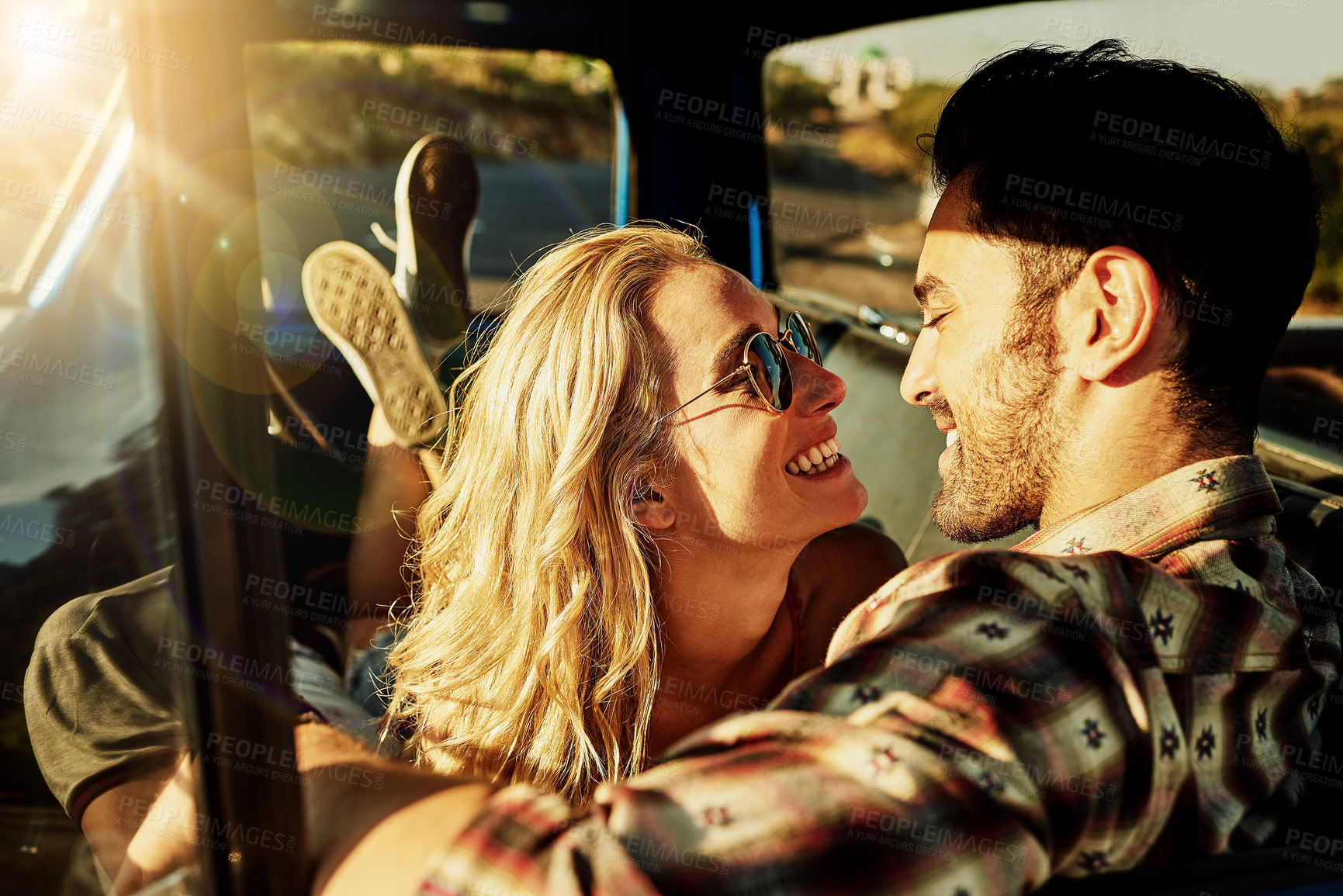 Buy stock photo Shot of a young couple out on a road trip with their truck