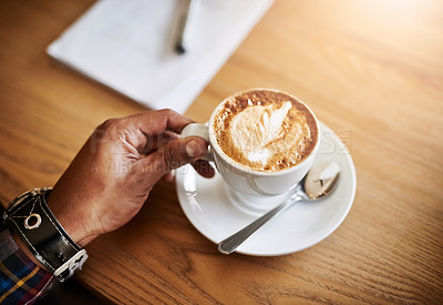 Buy stock photo Shot of an unidentifiable man having a cup of coffee in a coffee shop