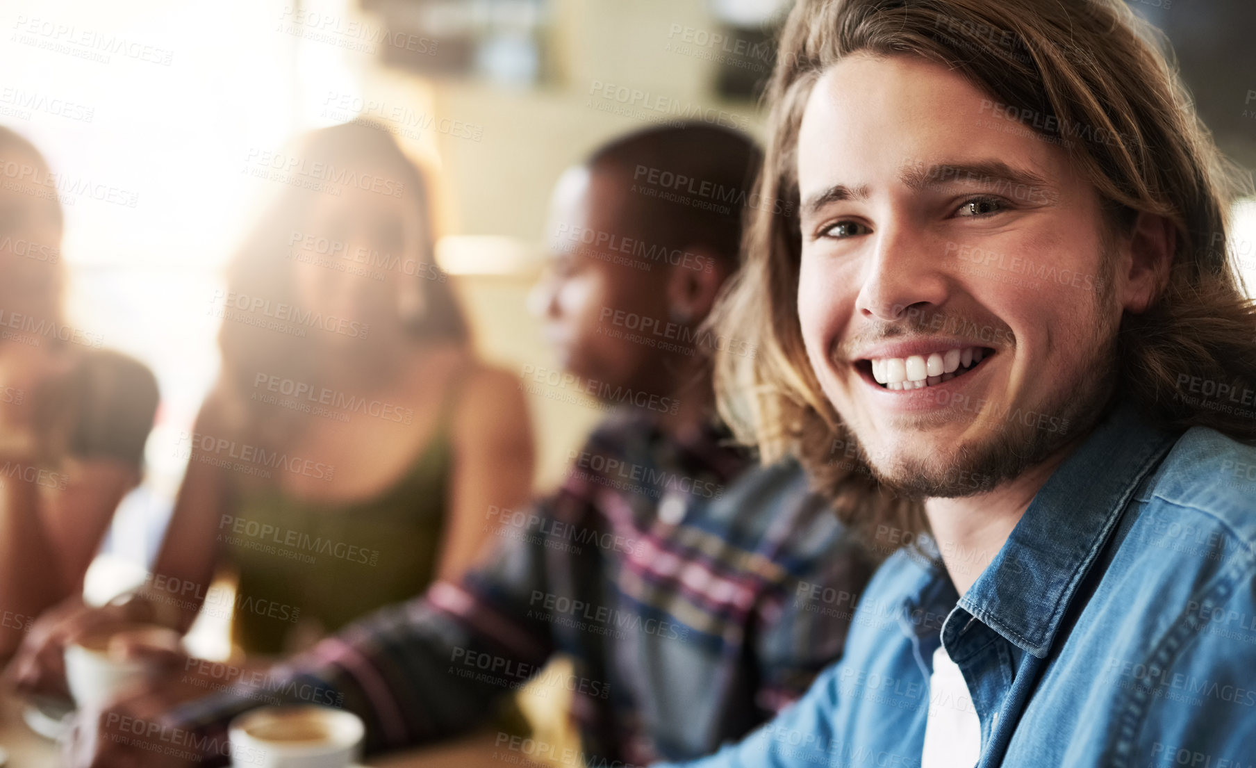 Buy stock photo Portrait of a man having coffee with friends in a coffee shop