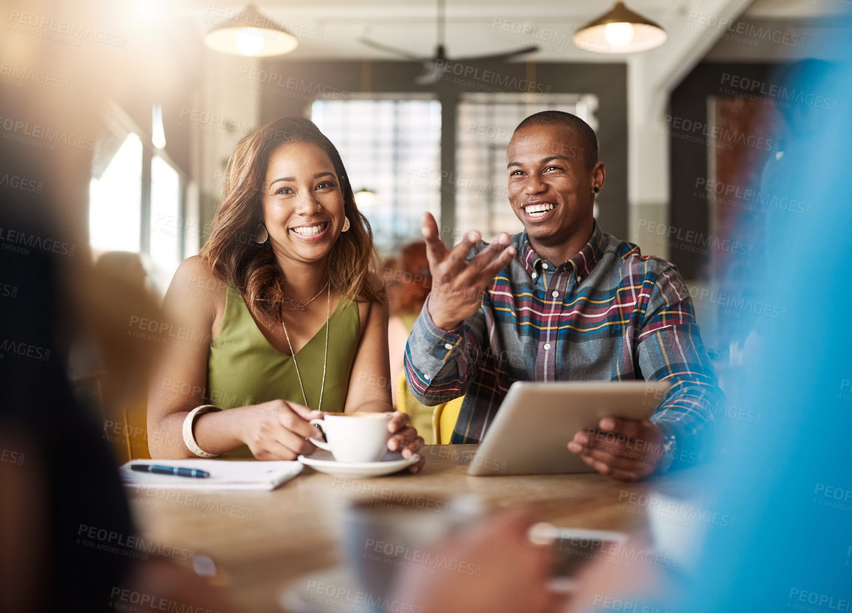 Buy stock photo Happy, friends and teamwork in cafe for tablet, research and discussion for english assignment. Campus, laughing students and education in college for studying, academic essay and notes with coffee