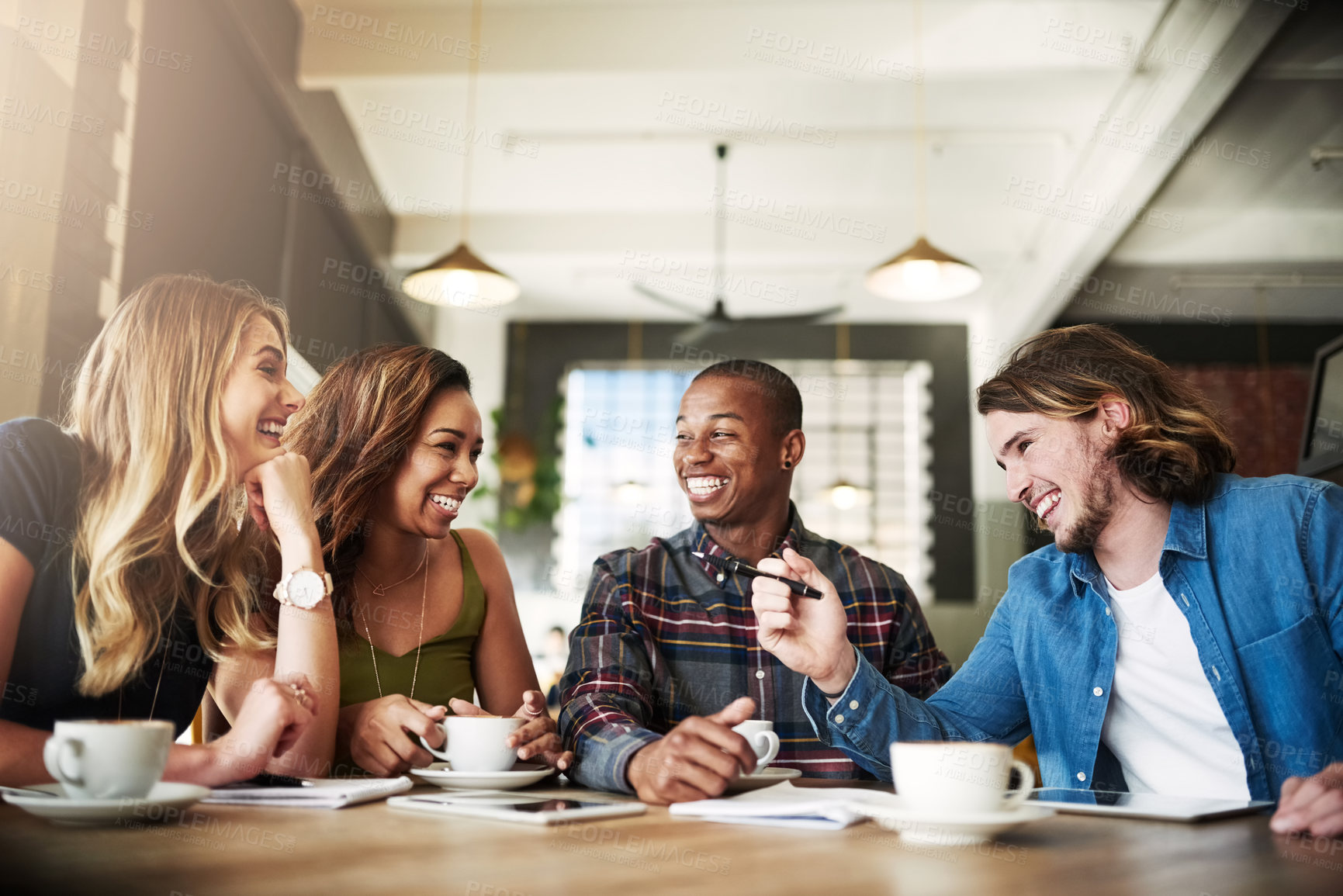 Buy stock photo Shot of a group of friends catching up over coffee in a coffee shop