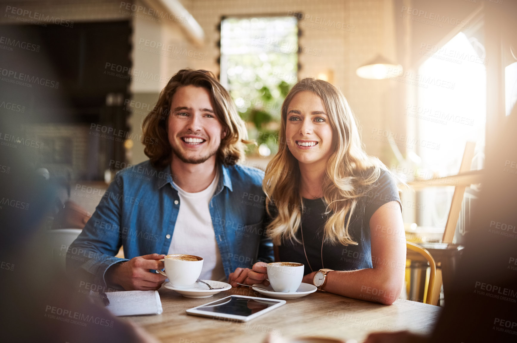 Buy stock photo Shot of a couple enjoying a double date with friends in a coffee shop