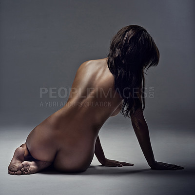 Buy stock photo Rearview shot of a beautiful woman posing nude in the studio