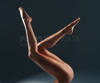 Buy stock photo Beauty, woman and closeup of legs in a studio for hair removal, epilation or waxing routine. Skincare, natural and zoom of female person body with shaving or depilation treatment by gray background.