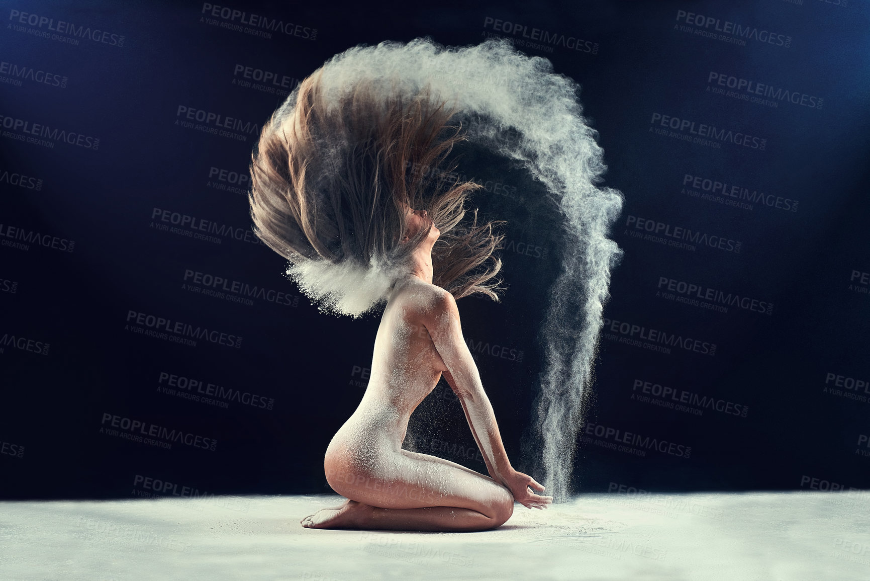 Buy stock photo Studio shot of a young woman leaving a trail of powder in the air by whipping her hair