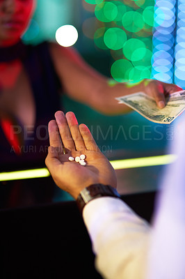 Buy stock photo Closeup shot of a woman buying drugs from a man in a nightclub