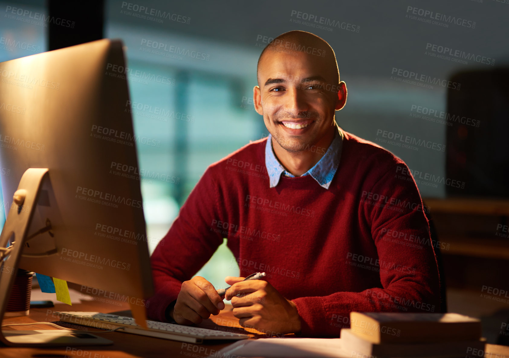 Buy stock photo Portrait of a handsome young man working late in his office