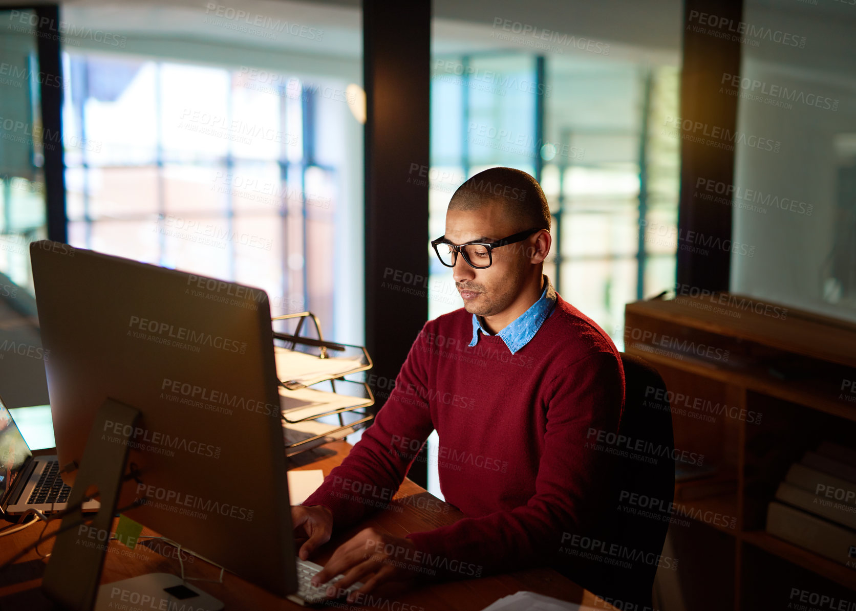 Buy stock photo Night, typing and businessman with computer, glasses and planning for online project at networking agency. Research, internet and consultant at desk writing article, review or report in dark office