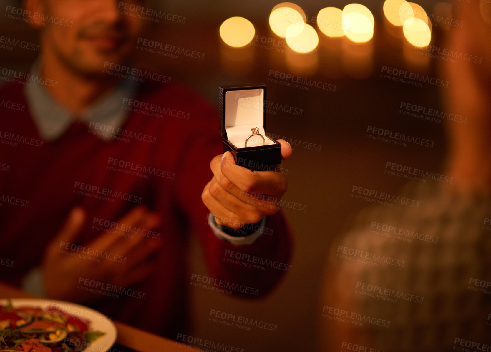Buy stock photo Cropped shot of an unrecognizable man proposing to his girlfriend