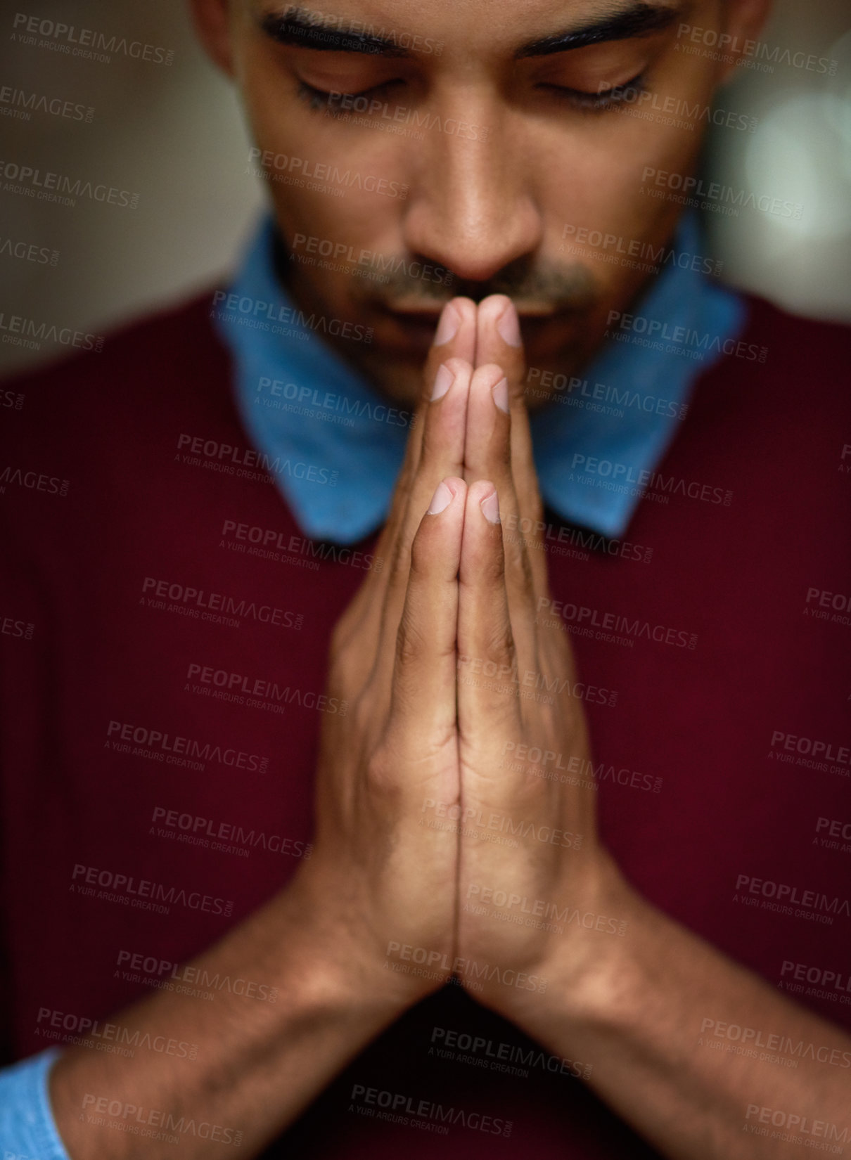 Buy stock photo Cropped shot of a young man holding his hands together in prayer
