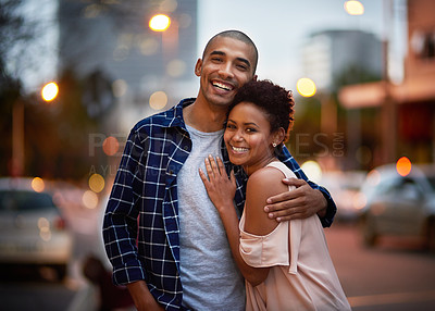 Buy stock photo Cropped portrait of an affectionate young couple out on a date in the city