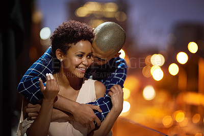 Buy stock photo Cropped shot of an affectionate young couple out on a date in the city