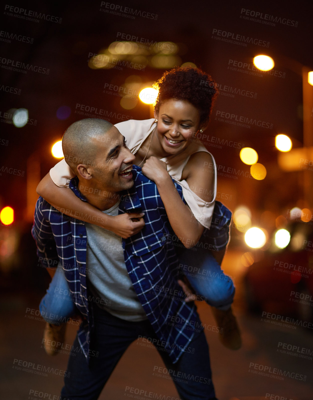 Buy stock photo Cropped shot of an affectionate young couple out on a date in the city