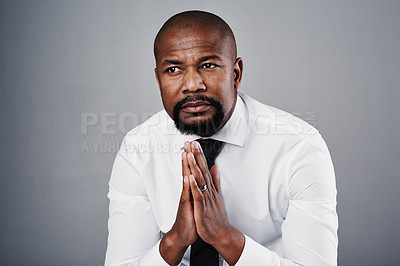 Buy stock photo Studio shot of a corporate businessman looking thoughtful against a grey background