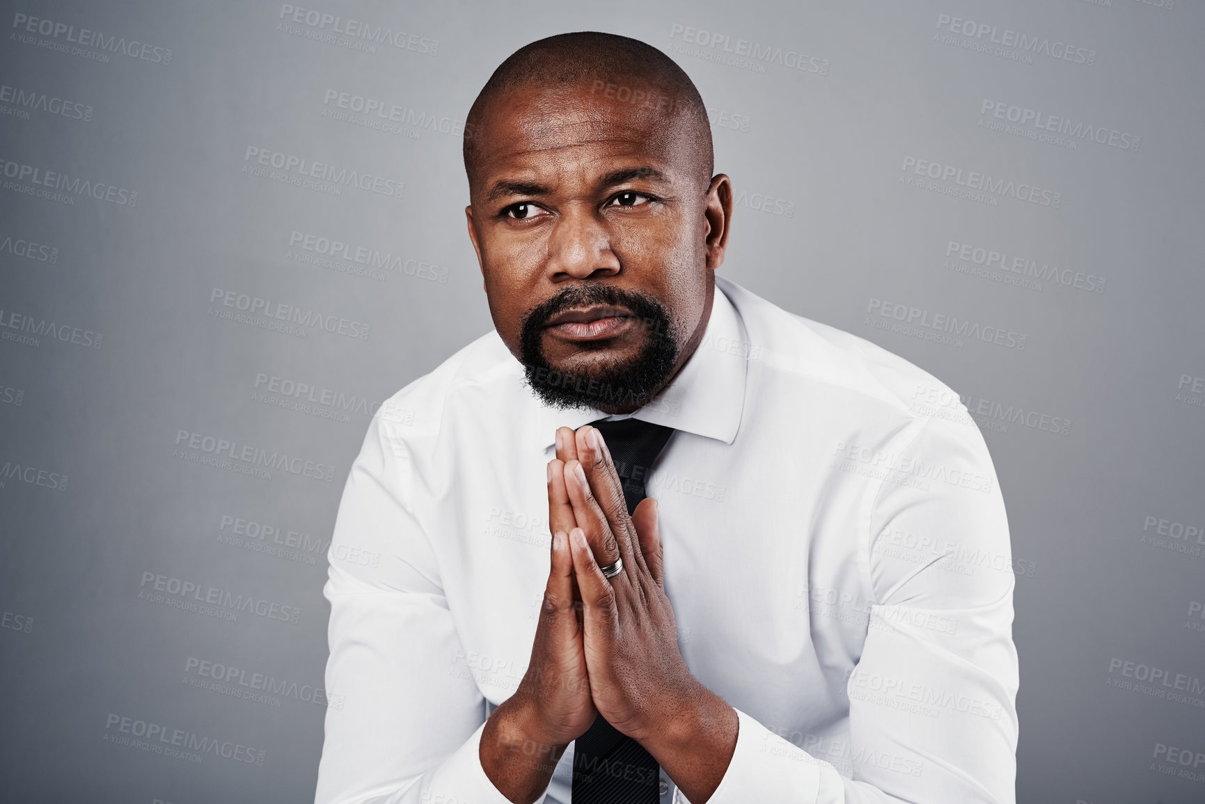 Buy stock photo Studio shot of a corporate businessman looking thoughtful against a grey background