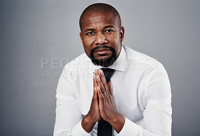 Buy stock photo Studio portrait of a corporate businessman posing against a grey background