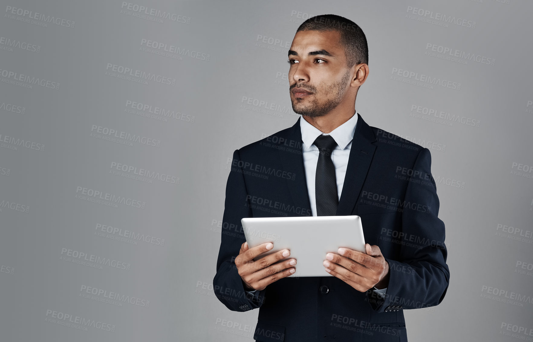 Buy stock photo Businessman, trader and thinking with tablet in studio for profit, revenue or app on a gray background. Man, broker or investor with technology in wonder for return on investment or mockup space