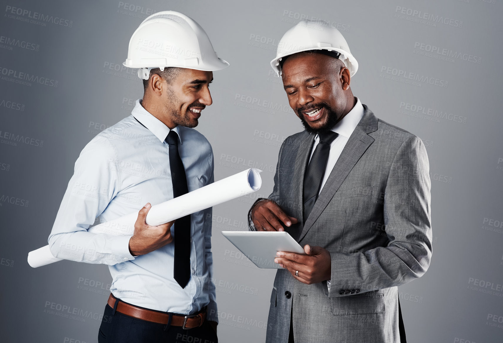 Buy stock photo People, architect and communication with tablet in studio of building safety, research and renovation schedule. Men, talk and information, blueprint and floor plan with maintenance on gray background