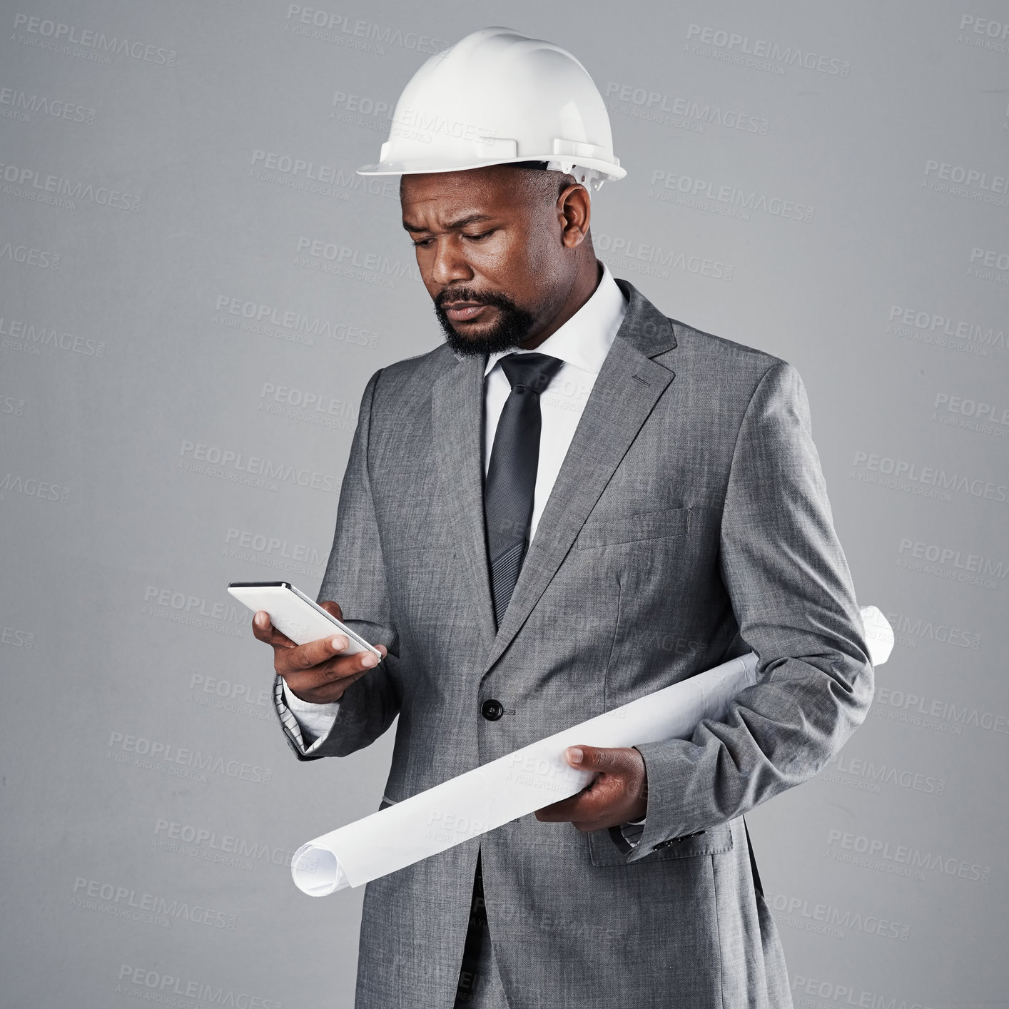 Buy stock photo Architecture, blueprint and businessman with phone in studio with design, floorplan and building project. Construction, gray background and engineer on smartphone for contact, research and planning